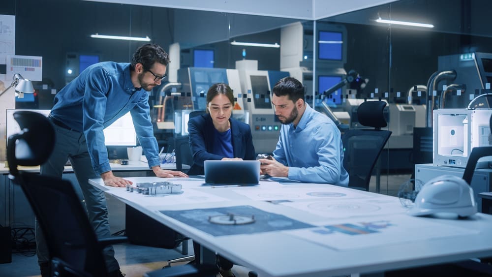 Factory Office Meeting Room: Team Of Engineers Gather Around Conference